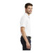A man wearing a white Port Authority Dry Zone white polo shirt.