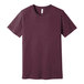 A Bella + Canvas heather maroon t-shirt with a small logo on the front.