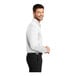 A man wearing a white Port Authority® long sleeve polo shirt.