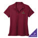 A women's red Nike polo shirt with green embroidery on the chest.