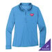 A Carolina blue Port Authority women's long sleeve polo shirt with a logo on it.