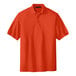 A Port Authority orange short sleeve polo shirt.