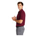 A man in a maroon Nike Polo shirt.