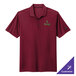 A maroon Nike Dri-FIT polo shirt with a logo on it.