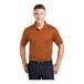 A man wearing a Texas orange Sport-Tek short sleeve polo shirt.