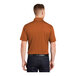 A man wearing a Texas orange Sport-Tek polo shirt.