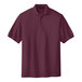 A maroon Port Authority® silk touch pique polo shirt.