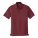 A Port Authority burgundy short sleeve polo shirt.