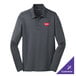 A Port Authority unisex steel gray long sleeve polo shirt with a logo on the counter.