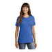 A woman wearing a royal blue Port & Company t-shirt.