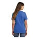 A woman wearing a royal blue Port & Company t-shirt.