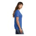 A woman wearing a royal blue Port & Company v-neck t-shirt.