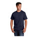 A man wearing a navy Port & Company T-shirt.