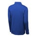 A back view of a blue long sleeve Sport-Tek polo shirt on a mannequin.