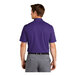 A man wearing a purple Nike polo shirt.