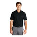 A man wearing a black Nike dri-fit polo shirt.