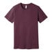 A medium heather maroon Bella + Canvas t-shirt with a small logo on the front.