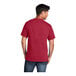 A man wearing a Port & Company red short sleeve t-shirt.