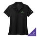 A black Nike women's polo shirt with green embroidery.