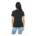 A woman wearing a dark gray Bella + Canvas t-shirt.