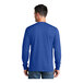 A man wearing a royal blue Port & Company long sleeve T-shirt.