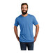 A man wearing an azure blue AllMade short sleeve t-shirt.
