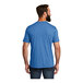 A man wearing an azure blue AllMade short sleeve T-shirt.