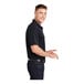 A man wearing a black Sport-Tek moisture-wicking polo.