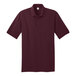 A Port & Company maroon short sleeve polo shirt.