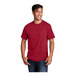 A man wearing a Port & Company red short sleeve t-shirt.