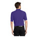 A man wearing a purple Port Authority® silk touch polo shirt.