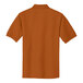 A Texas orange Port Authority polo shirt with a white collar.