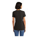 A woman wearing a black District short sleeve t-shirt.