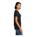 A woman wearing a black District combed cotton T-shirt.