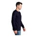 A man wearing a Port & Company navy long sleeve shirt.