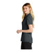 A woman wearing a black Nike short sleeve polo shirt.