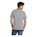 A man wearing a Port & Company athletic heather grey short sleeve t-shirt.