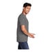 A man in a Port & Company medium gray T-shirt smiling.