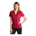 A woman wearing a red Nike polo shirt.
