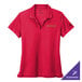 A Nike red women's performance polo shirt with a logo on it.