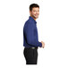 A man wearing a Port Authority royal blue long sleeve polo shirt.
