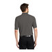 A man wearing a Charcoal Heather Gray Port Authority polo shirt.
