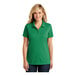 A woman wearing a bright kelly green Port Authority polo shirt with short sleeves.