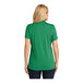 A woman wearing a Port Authority Dry Zone bright kelly green polo shirt.