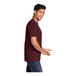 A man in a Port & Company maroon short sleeve t-shirt smiling.