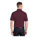 A man wearing a maroon Sport-Tek moisture-wicking polo shirt.