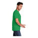 A man in a Port & Company clover green short sleeve T-shirt.