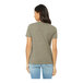 A woman wearing a heather grey Bella + Canvas customizable t-shirt.