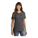 A woman wearing a charcoal Port & Company short sleeve T-shirt.