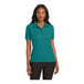 A woman wearing a teal green Port Authority polo shirt.